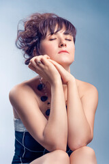 Portrait of Winsome Sexy Sensual Caucasian Woman With Bright Makeup Curly Hairdo Posing Over Color Background As Concept of Cosmetics, Makeup and Rejuvenation