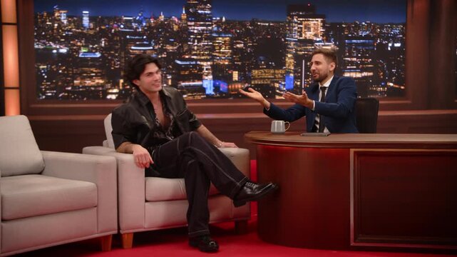 Male Late-night Host Chats With a Male Actor, Swapping Punchy Jokes, Celebrity Gossip, Career Stories in a Lively Interview. Screen Replacement. Mockup Playback Cable Channel Television Studio
