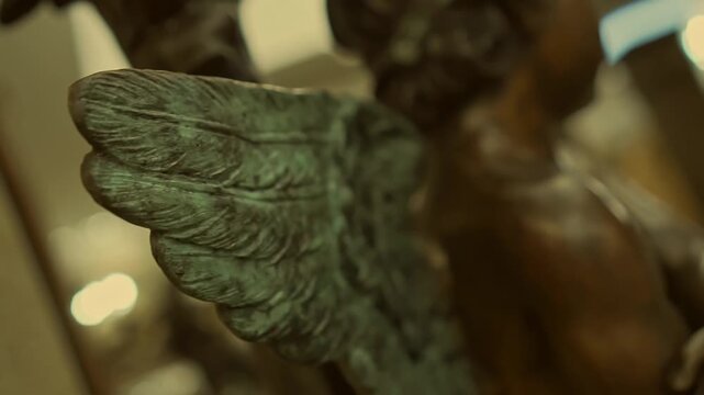 Statue of a little angel in a European hotel. Bronze statue of a child angel with wings.