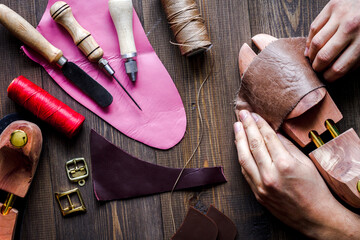 cobbler tools in workshop dark background top view