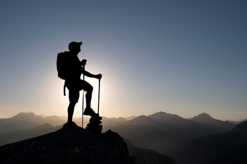 Backpacker Man Reaching Summit Above Mountains Landscape Freedom and Achievement Concept