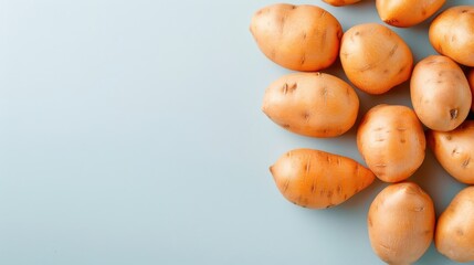 Artistic display of sweet potatoes arranged in a spiral pattern on a minimalistic background.