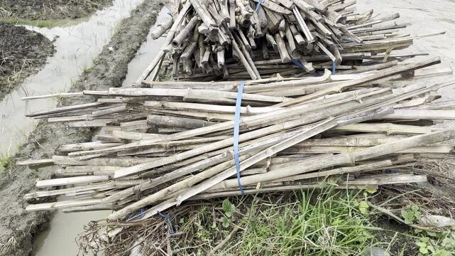 pile of wood and tied with raffia rope