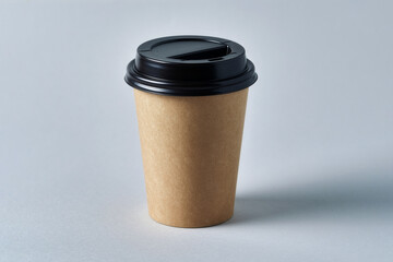 Minimalist craft paper coffee cup mockup with black lid on gray background
