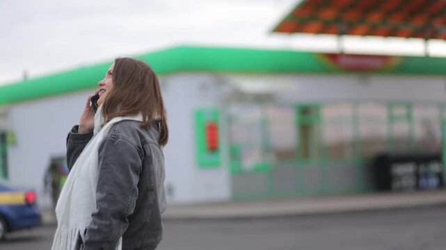 A woman uses a smartphone outside in cold weather