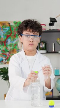 Young Student in Lab Coat Performing Bernoulli's Principle Science Experiment