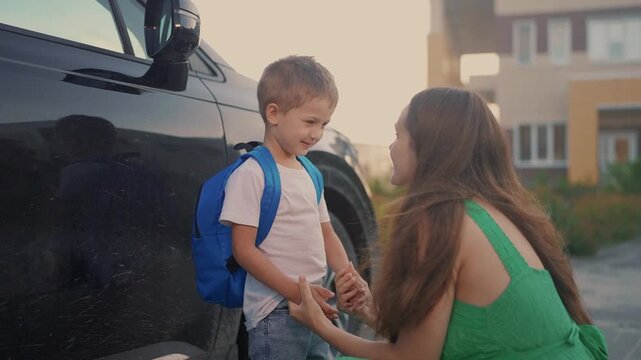 Back to school. Mom meets her son at school. Child mother family concept. Mom brings her boy son back to lifestyle school. Mom returns her son to. school. education concept.