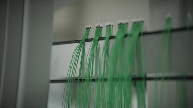 Automated robot hangs finished temperature sensor wires onto a storage rack