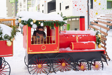 Woman sitting in toy train in winter