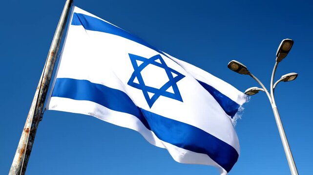 Israeli flag waving in blue sky