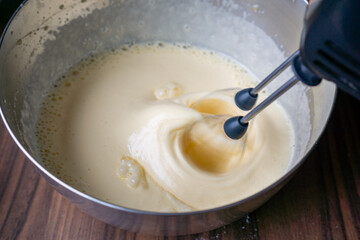 Mixing cake batter with electric hand mixer