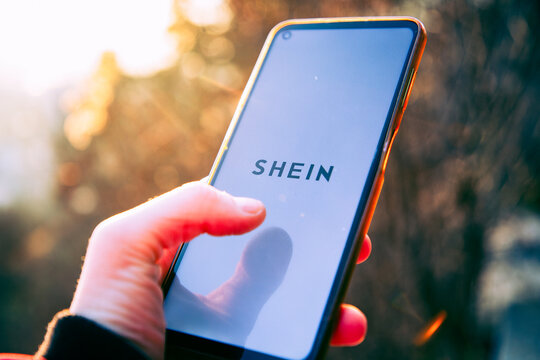 person opening shein app on a phone