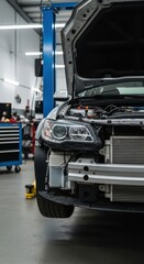 Obraz premium Front view of car with open hood in modern auto repair shop showing engine details and workshop equipment