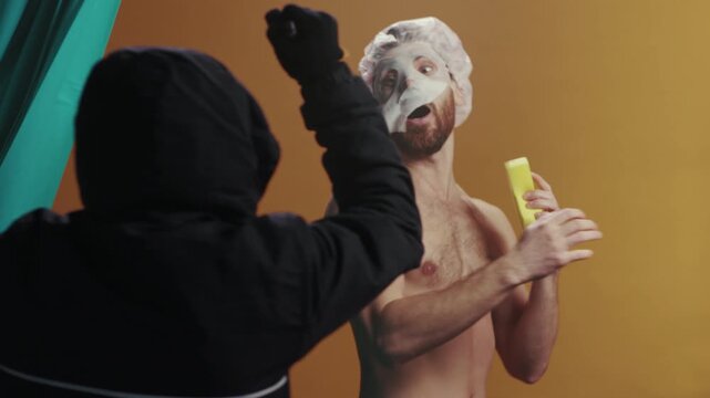 Intruder frightens audience, Concealed assailant with weapon incites suspense through lighting and shadow effects