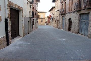 Fototapeta premium Historic buildings and tower of Iglesia de Santa Maria de Los Arcos on Camino de Santiago Frances in Navarra Spain July 2024