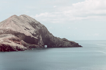 Vintage coastal panorama of Ponta de Sao Lourenco Madeira east coast headland, calm Atlantic water frames eroded volcanic slopes creating soft nostalgic travel atmosphere