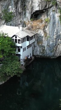 An aerial view of the Ottoman monastery of Blagaj Tekija, built into a cliff at the source of the Buna River, Bosnia and Herzegovina