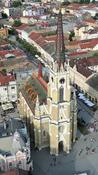 A drone flies over the Church of St. Mary in Novi Sad, showing the Old Town in the background