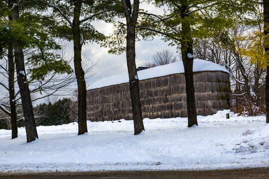 Iroquoian village in winter. A longhouse in a reconstructed 15th-century village. Milton, Crawford Lake, Ontario, Canada.