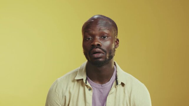 Portrait of reflective African American man during monologue with warm background and natural skin tones