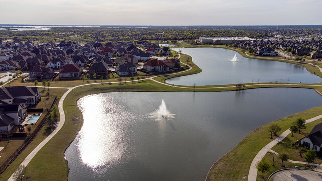 Aerial view of tranquil waters reflecting the sky, nestled among the homes and green spaces, Dallas, Texas, United States.