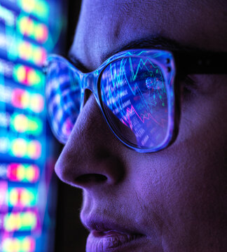 Female analyst viewing financial market data on a screen