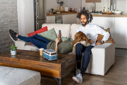 Couple relaxing on couch, planning their road trip