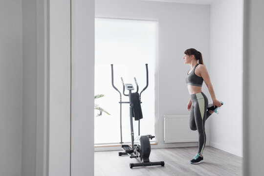 Woman performing stretching exercises before a workout at home