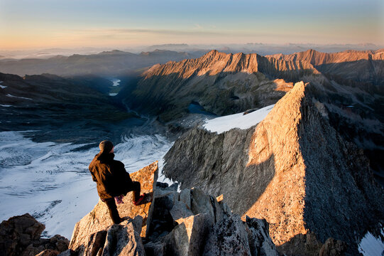 Austria, Tyrol, Zillertal Alps, View from Reichenspitze, climber at glaciated mountains at sunrise, Wildgerlostal, High Tauern National Park
