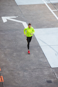 Young man running on parking level