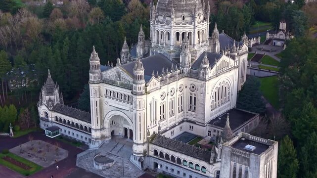 Detailed architecture, dome, and facade of Basilica of Saint Th&eacute;r&egrave;se in Lisieux, France. Aerial drone ascending