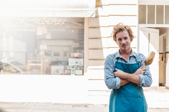 Portrait of confident coffee roaster in front of his his shop