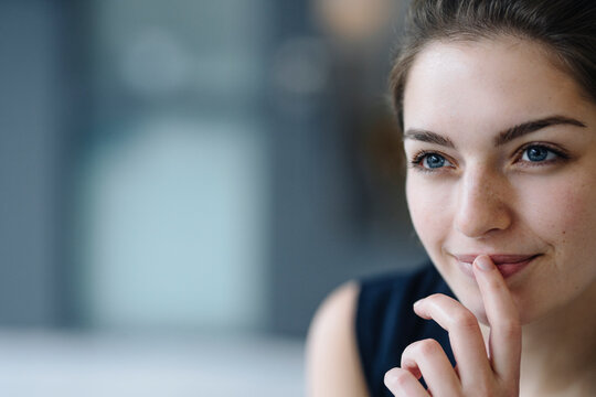 Portrait of smiling young woman looking at distance