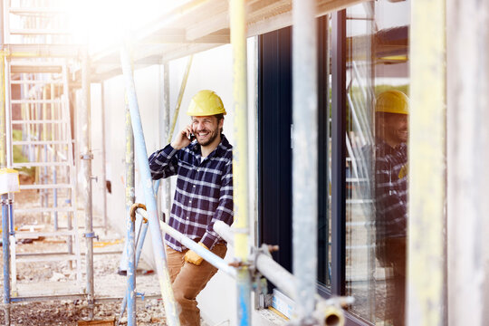 Happy worker on the phone a construction site