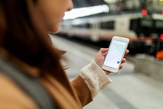 Close-up of woman using cell phone at the train station