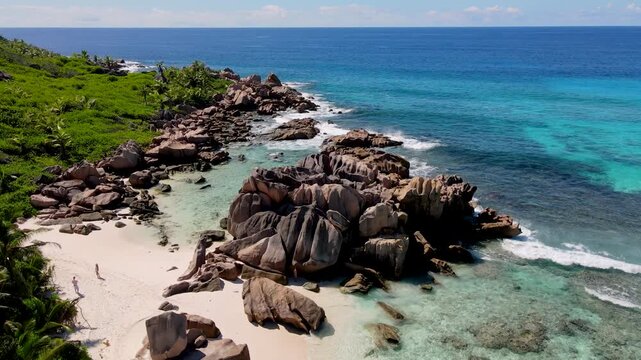 Experience the pristine beauty of Anse Cocos Beach, where turquoise waves gently kiss the shore. Explore lush greenery, unique rock formations, La Digue, Seychelles