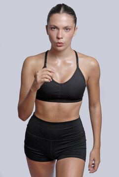 Trekking athletic fitness young woman training on neutral background.