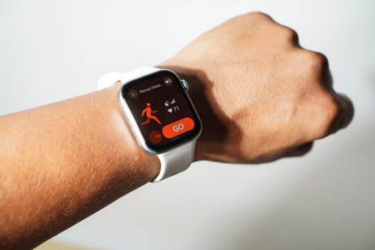 South Sulawesi, Indonesia, February 13, 2026: Close-up of a HUAWEI WATCH FIT 4 running watch on a man's wrist, showing a ready-to-run time with a heart rate of 71bpm against a gray background.