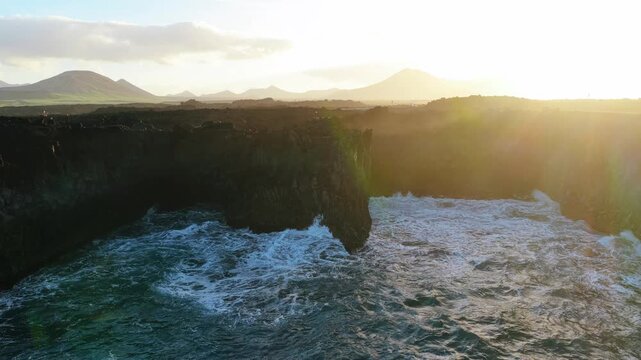 Los Hervideros is a dramatic stretch of volcanic coastline in Yaiza, Lanzarote, where the Atlantic Ocean crashes into sea caves and basaltic cliffs. Formed during the Timanfaya eruptions between 1730 