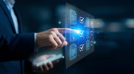 Fototapeta premium A man in a suit is interacting with a glowing holographic digital document management system, selecting and reviewing virtual files and checkboxes on a dark background.