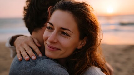 A couple shares a tender embrace on a serene beach at sunset bathed in the warm golden light of the setting sun