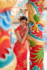 Beautiful young woman with Chinese Cheongsam dress in Chiang Mai, Thailand.