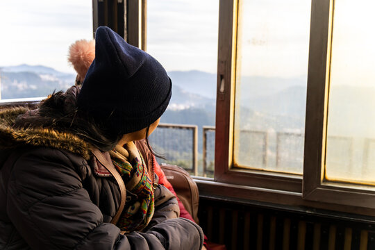 solo woman embracing mountain landscape through kalka shimla toy train