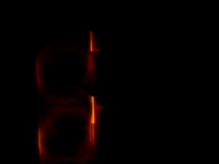 colorful light trails in dark background. Abstract light routes that rotate in vibrant colors....