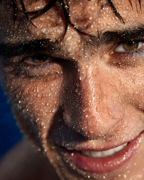 Close-Up of a Young Man with Water Droplets