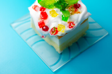 A colorful dessert with a green mint leaf on top © Q77photo