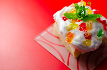 A colorful dessert with a green mint leaf on top © Q77photo