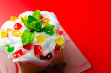 A colorful dessert with a green mint leaf on top © Q77photo