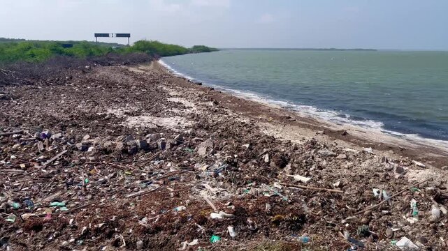 View of a garbage filled coastal area near the ocean