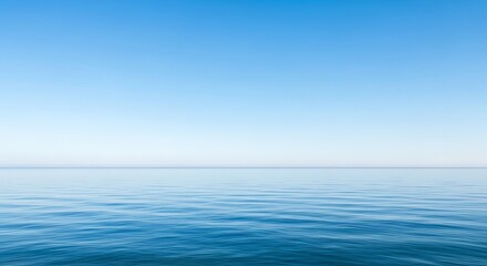 Fototapeta premium Serene seascape featuring a gradient of clear sky meeting the calming water